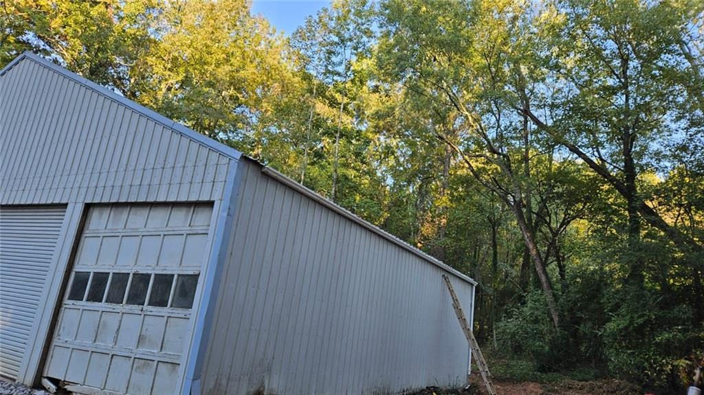 471 Perkins Circle Canton, GA 30115 - Photo 14 of 20 a view of a wooden house with a large window and wooden fence