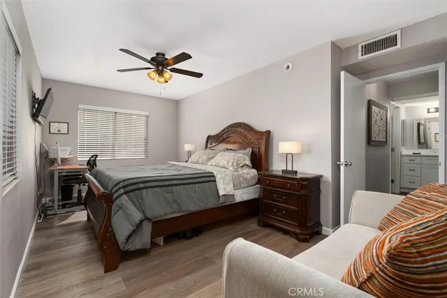 a bedroom with a bed and wooden floor