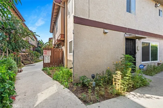 a couple of potted plants in front of door