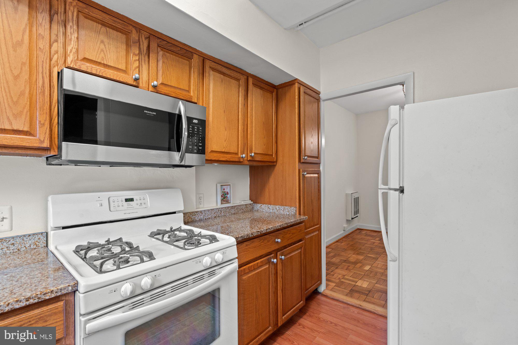 3304 Gunston Road Alexandria, VA 22302 - Photo 12 of 28 a kitchen with stainless steel appliances granite countertop a stove a refrigerator and a microwave