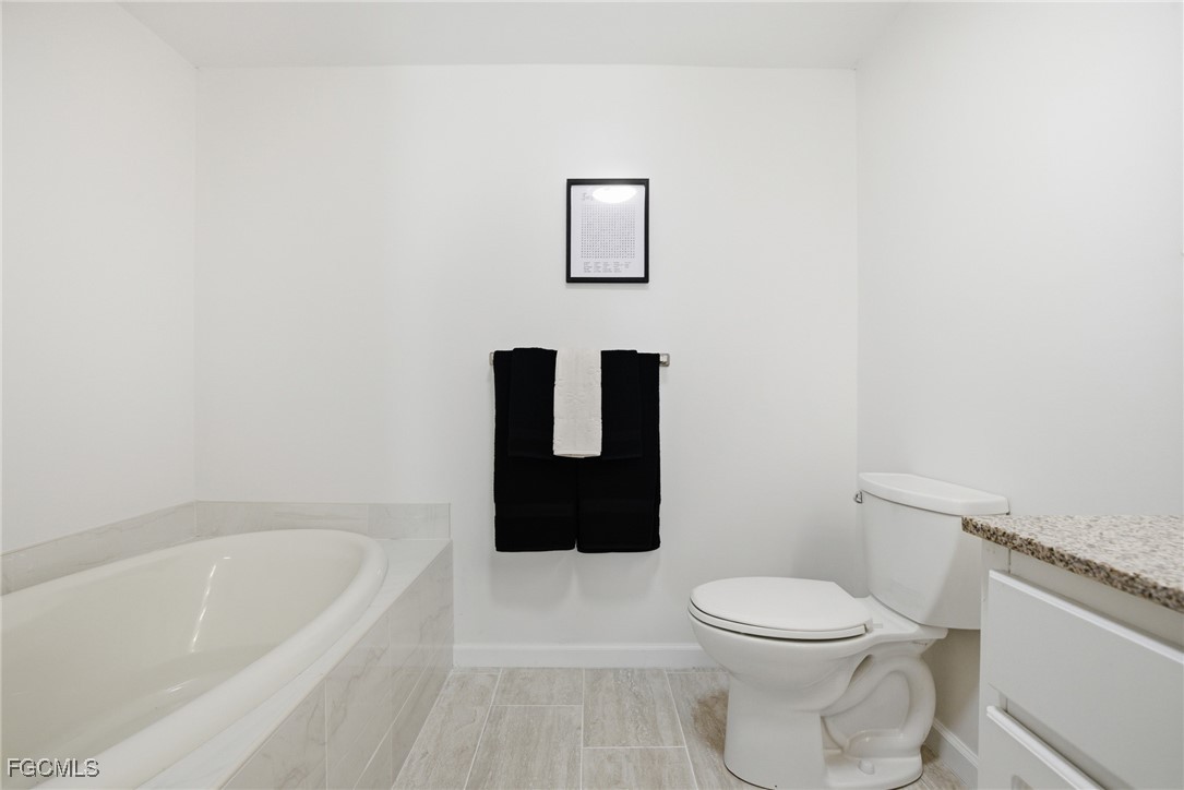 14736 Patrick Henry Road North Fort Myers, FL 33917 - Photo 18 of 47 a bathroom with a toilet and a bathtub