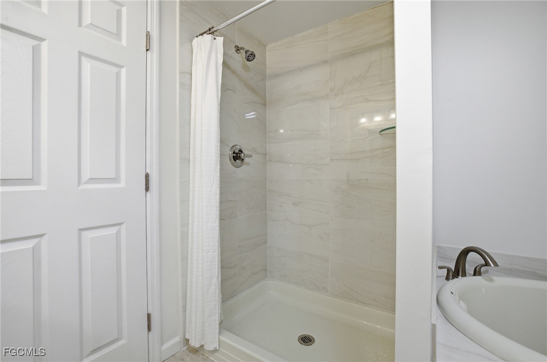 14736 Patrick Henry Road North Fort Myers, FL 33917 - Photo 19 of 47 a bathroom with a shower and a sink