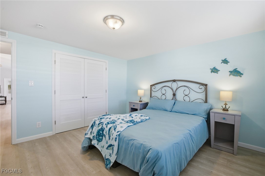 14736 Patrick Henry Road North Fort Myers, FL 33917 - Photo 23 of 47 a bedroom with a bed and a window