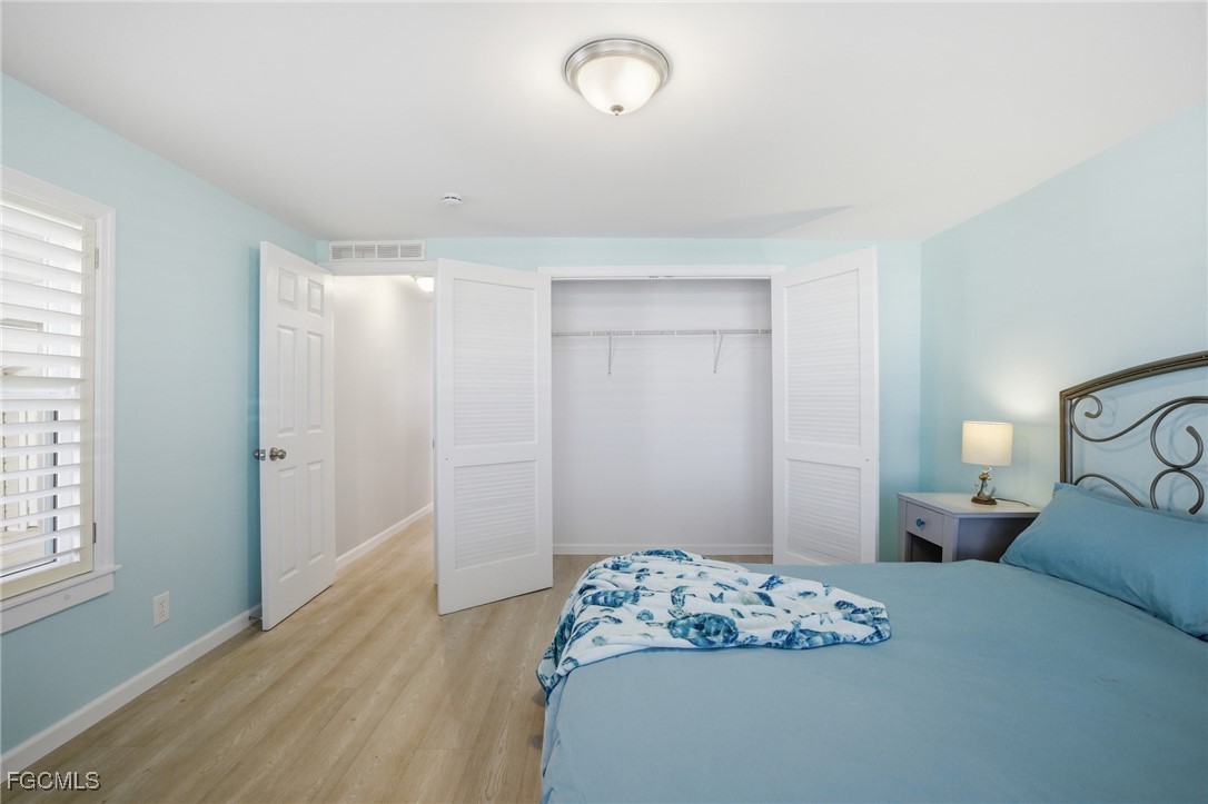 14736 Patrick Henry Road North Fort Myers, FL 33917 - Photo 25 of 47 a bedroom with a bed and a window