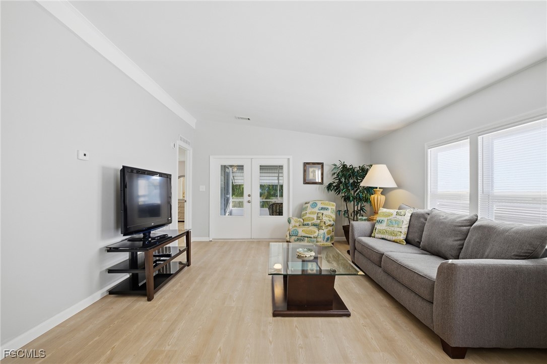 14736 Patrick Henry Road North Fort Myers, FL 33917 - Photo 4 of 47 a living room with furniture and a flat screen tv