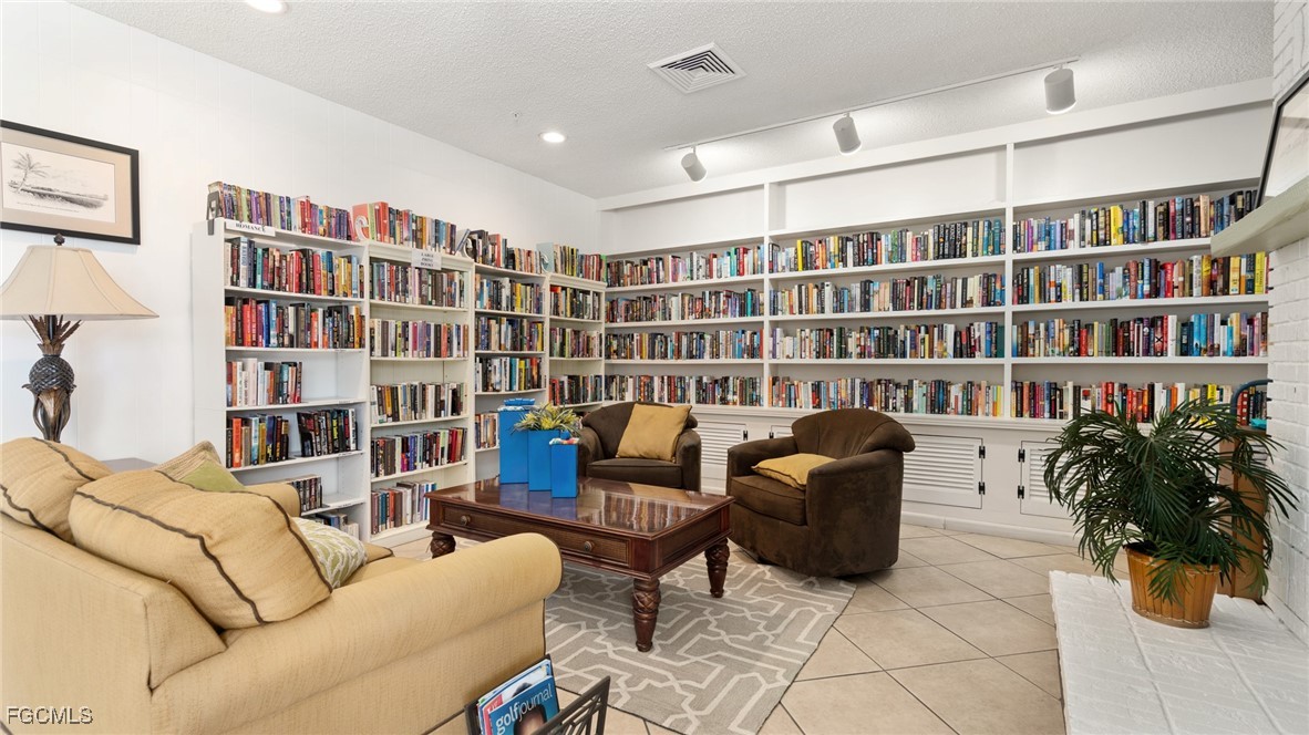 14736 Patrick Henry Road North Fort Myers, FL 33917 - Photo 45 of 47 a living room with furniture and book shelf