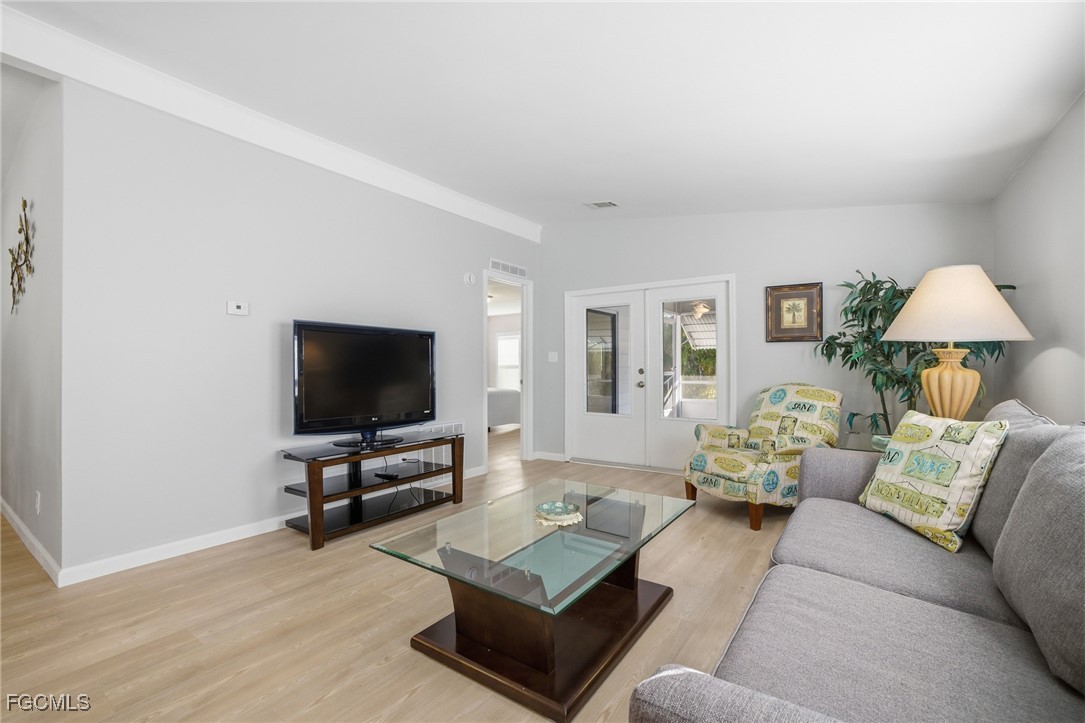 14736 Patrick Henry Road North Fort Myers, FL 33917 - Photo 5 of 47 a living room with furniture and a flat screen tv