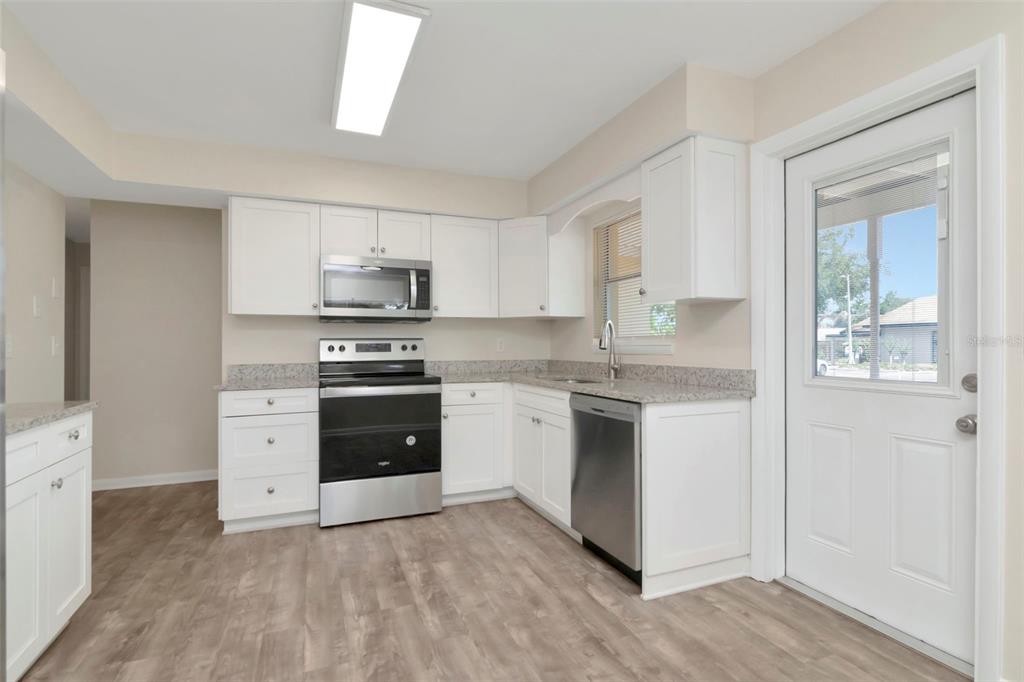 126 Kingsway Road Brandon, FL 33510 - Photo 23 of 42 a kitchen with white cabinets and appliances