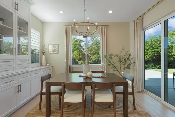 a large kitchen with kitchen island a island a sink and a dining table in it