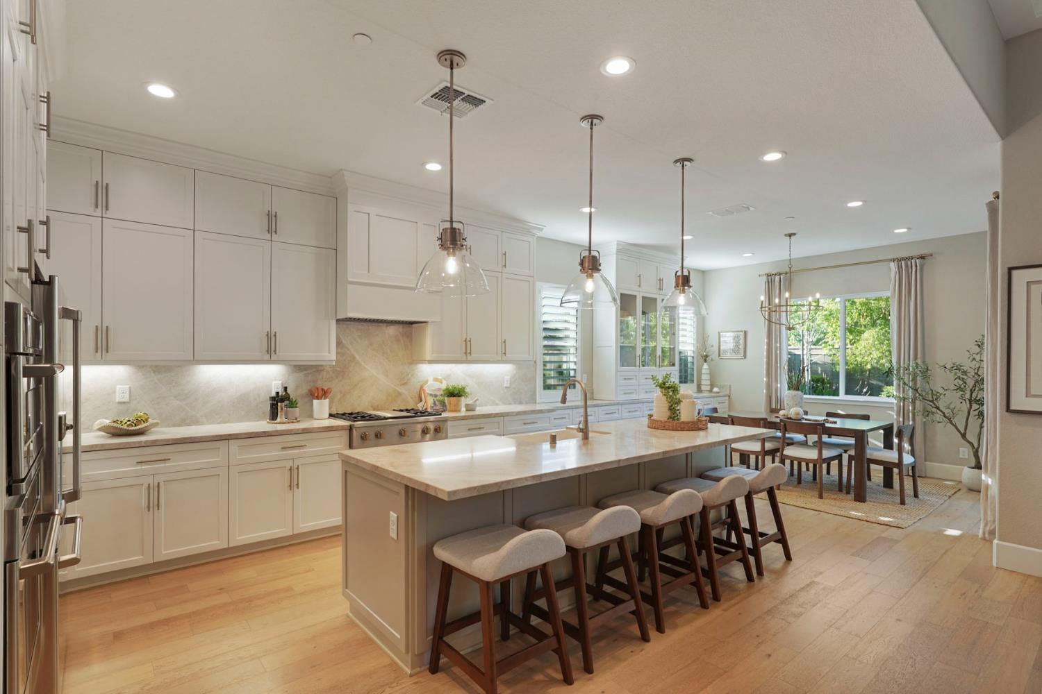 2931 Concerto Court Lodi, CA 95242 - Photo 22 of 54 a large kitchen with kitchen island a island a sink and a dining table in it