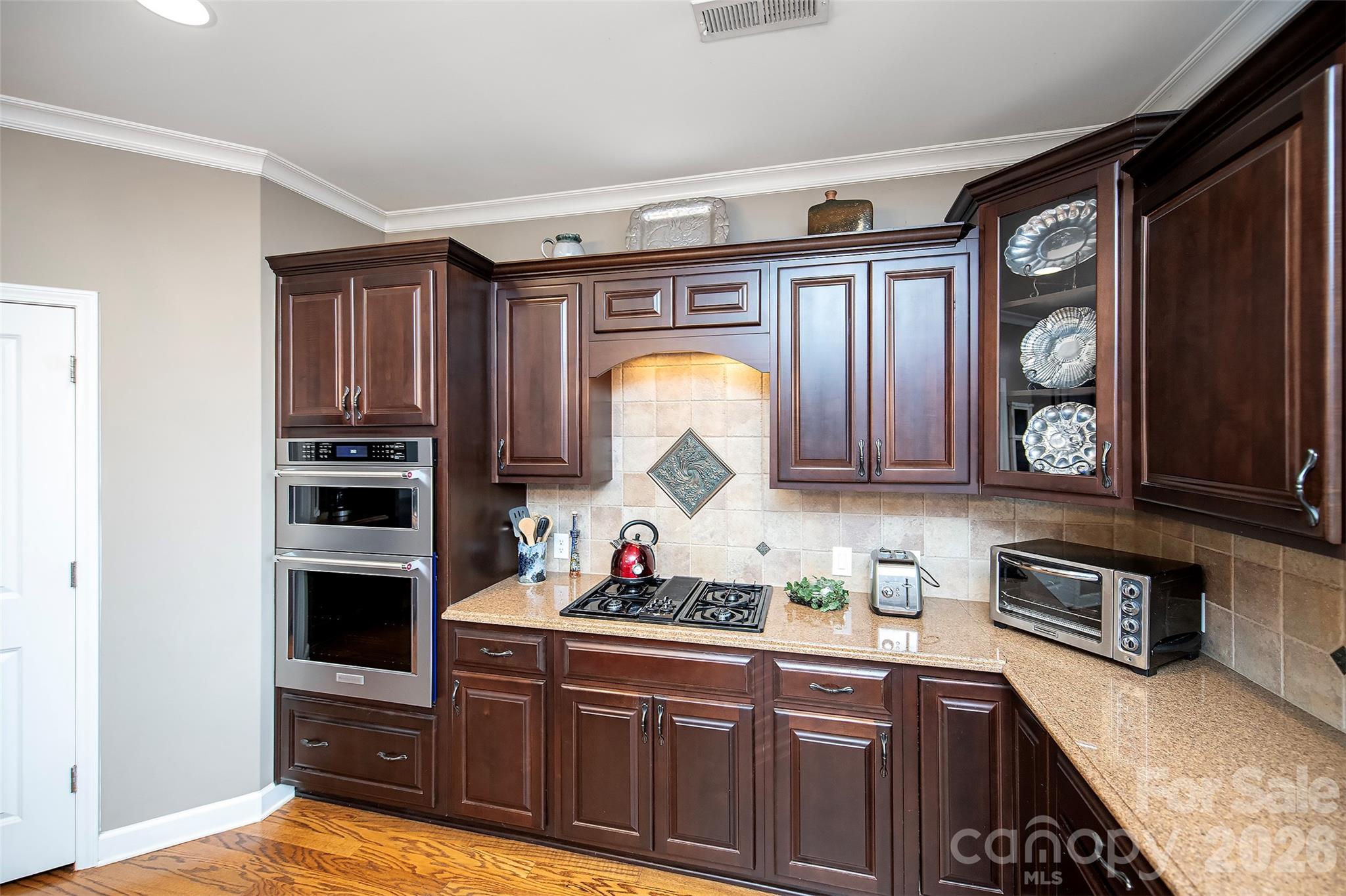 18432 East Marbella Lane Fort Mill, SC 29707 - Photo 16 of 47 a kitchen with stainless steel appliances granite countertop a stove and a microwave