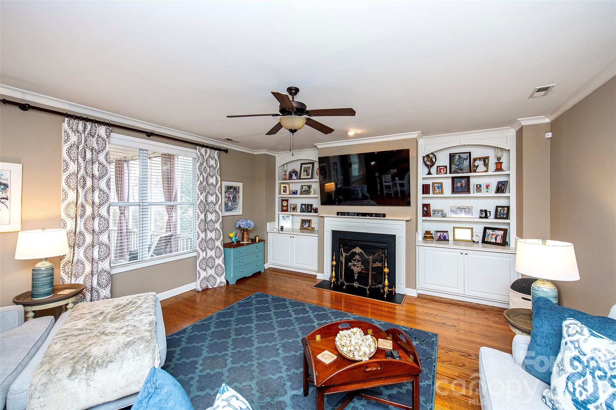 18432 East Marbella Lane Fort Mill, SC 29707 - Photo 9 of 47 a living room with furniture flat screen tv and a fireplace
