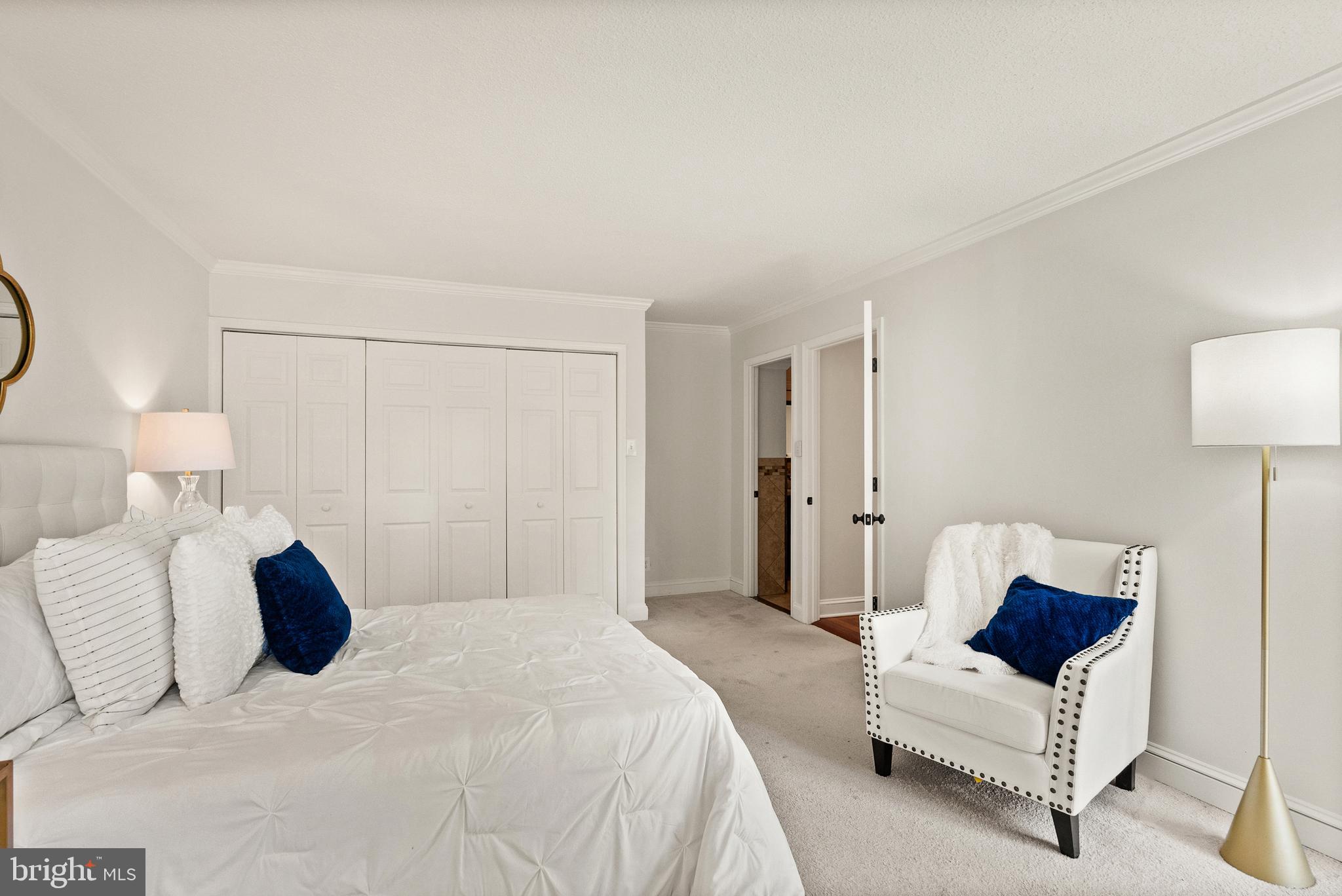 1401 North Rhodes Street, Unit 102 Arlington, VA 22209 - Photo 12 of 21 a bedroom with a bed and a lamp