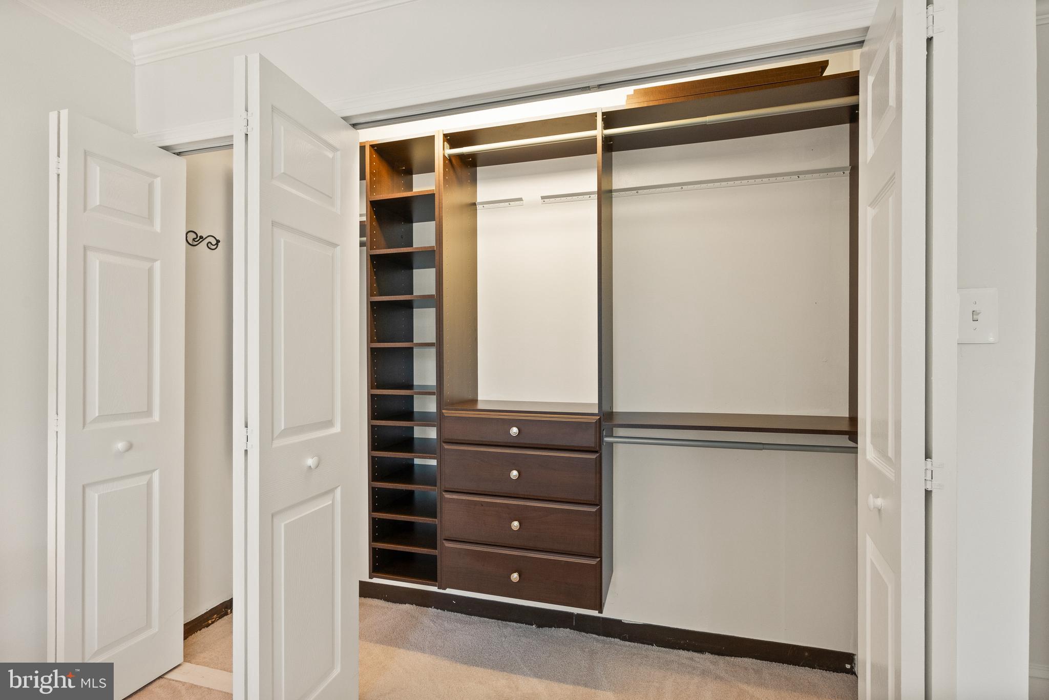 1401 North Rhodes Street, Unit 102 Arlington, VA 22209 - Photo 13 of 21 a view of walk in closet with empty racks