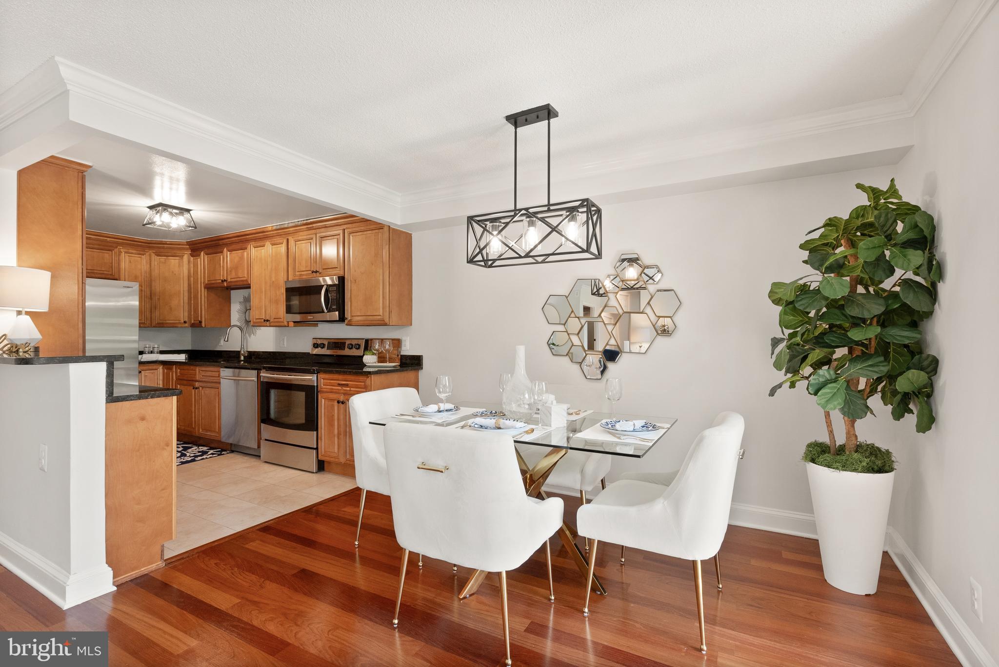 1401 North Rhodes Street, Unit 102 Arlington, VA 22209 - Photo 6 of 21 a view of a dining room with furniture wooden floor and chandelier