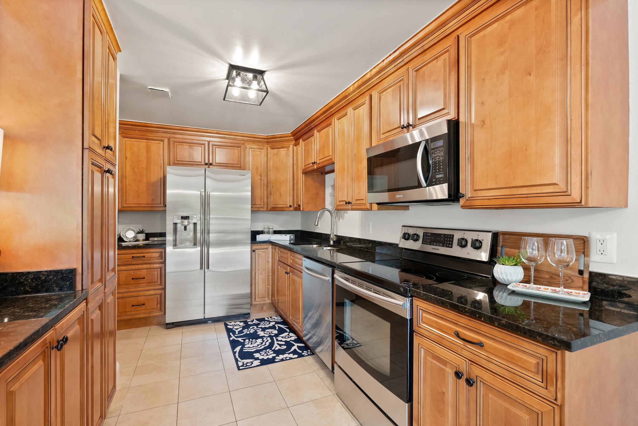 1401 North Rhodes Street, Unit 102 Arlington, VA 22209 - Photo 7 of 21 a kitchen with stainless steel appliances granite countertop a stove a sink and a refrigerator