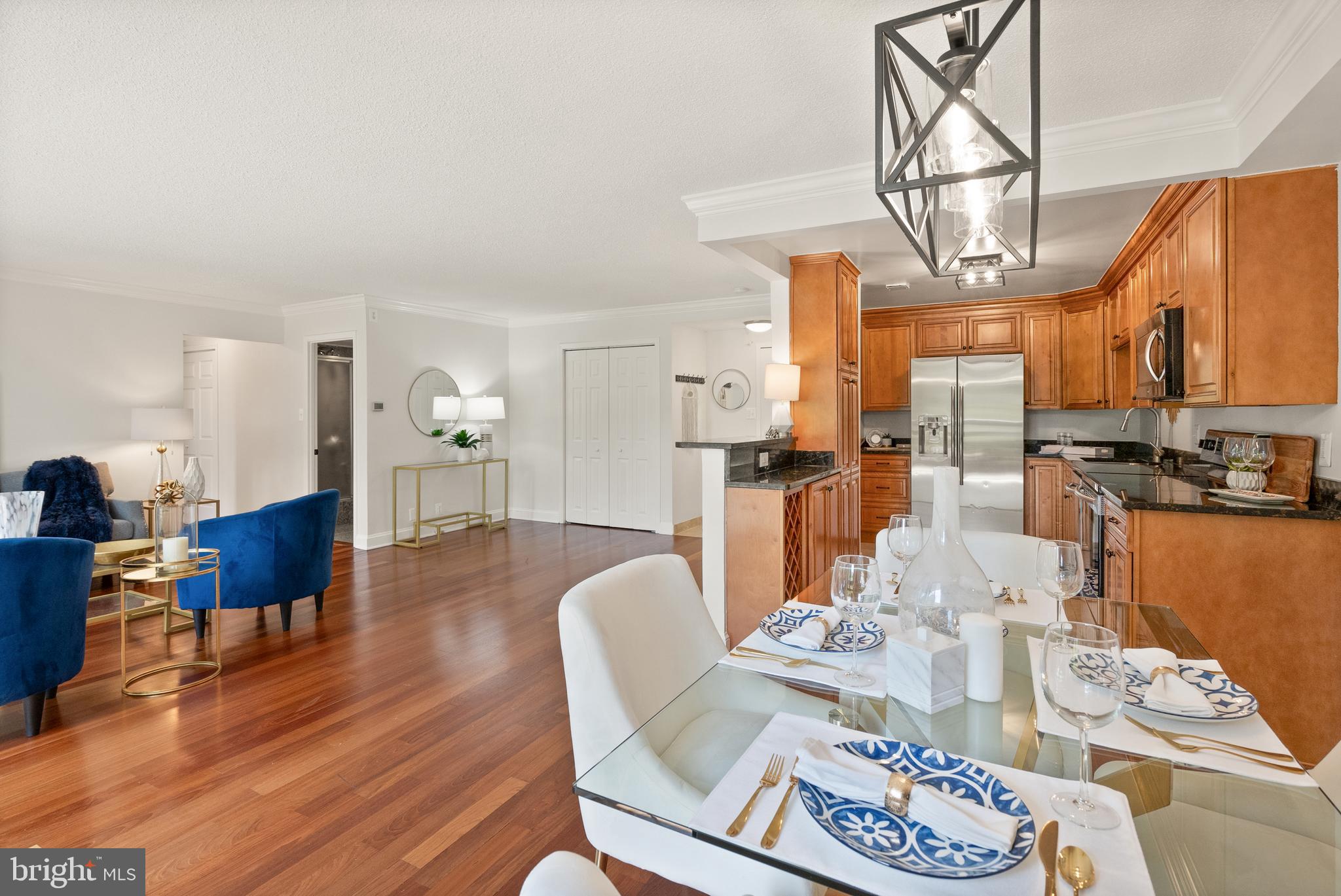 1401 North Rhodes Street, Unit 102 Arlington, VA 22209 - Photo 8 of 21 a dining room with furniture a kitchen view and chandelier