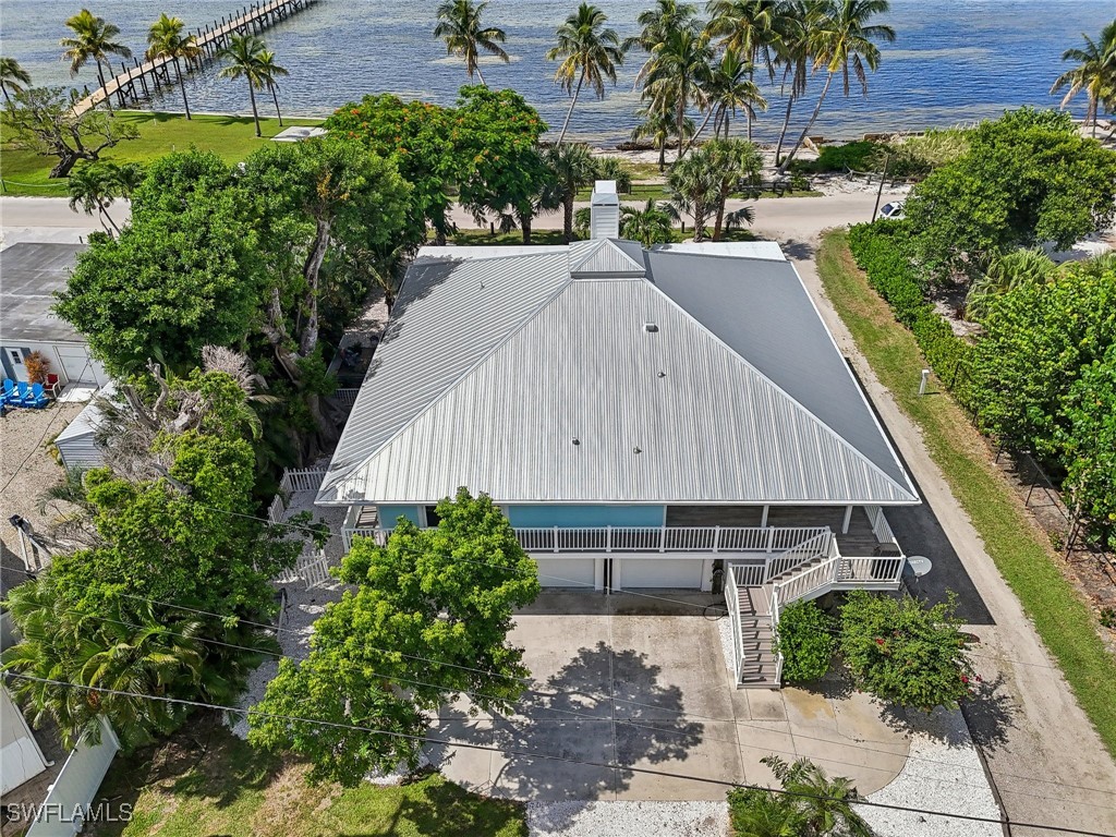 8335 Main Street Bokeelia, FL 33922 - Photo 12 of 47 an aerial view of a house roof deck with potted plants and large tree