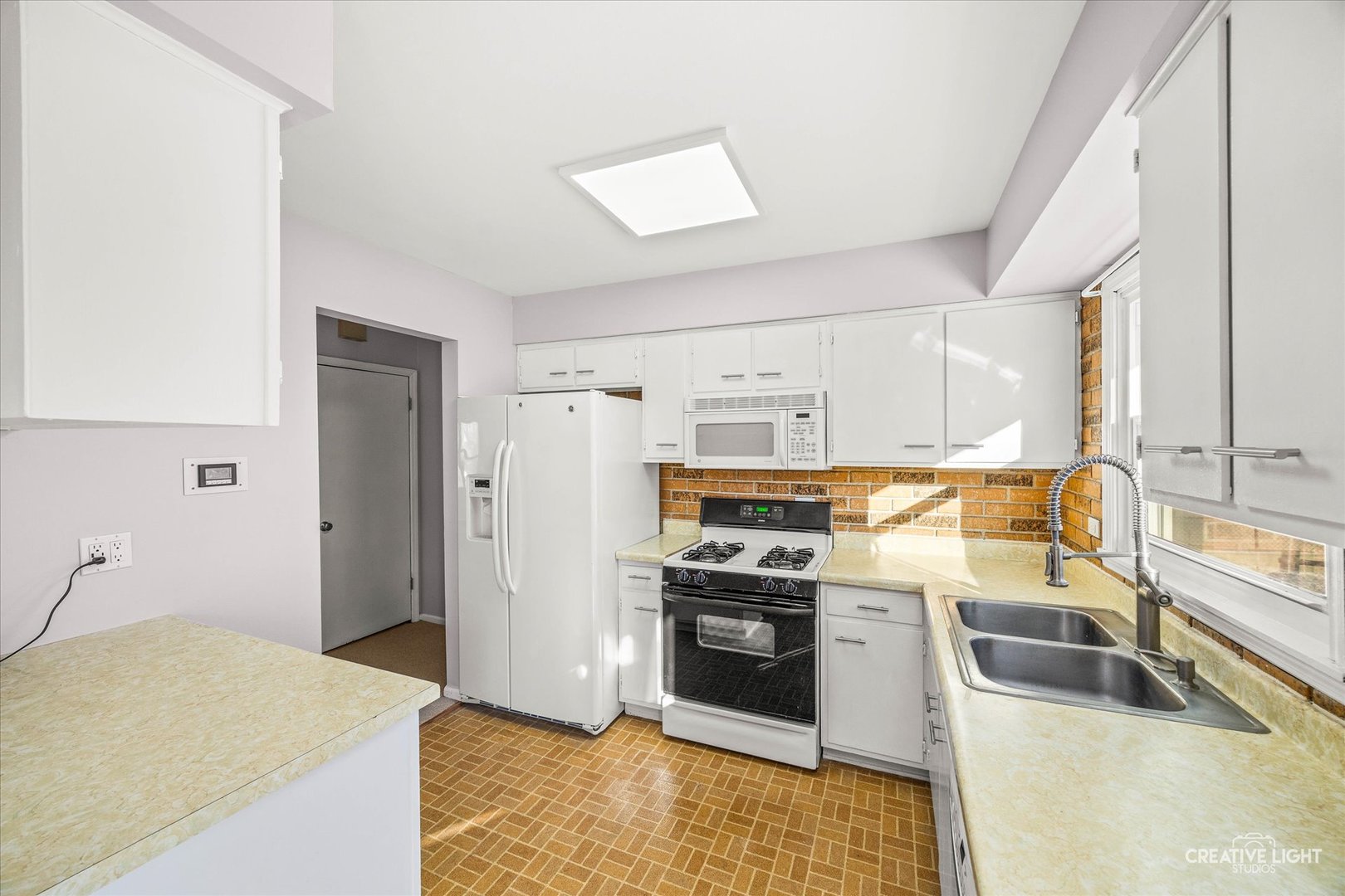 N071 Stanley Street Wheaton, IL 60187 - Photo 9 of 29 a kitchen with stainless steel appliances granite countertop a sink stove and refrigerator
