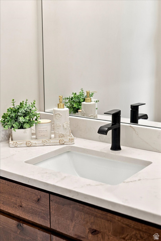 754 West 400 North Mapleton, UT 84664 - Photo 23 of 86 Half bathroom off of garage by kitchen. Undermount sink with a matte black single-handle faucet, set into a white countertop with a wood-finish vanity