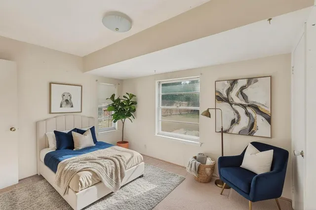 a bedroom with bed and a window