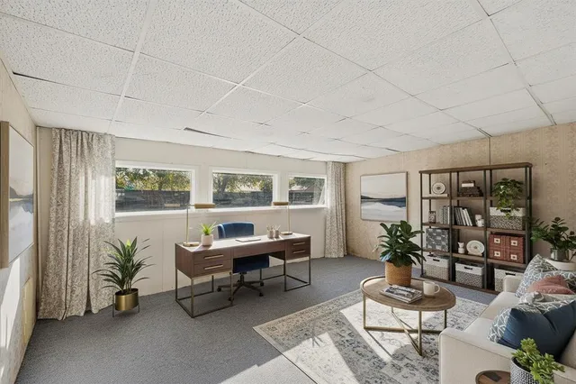 a living room with furniture a window and a table