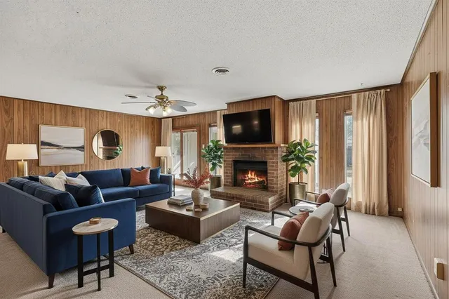 a living room with furniture a fireplace and a flat screen tv