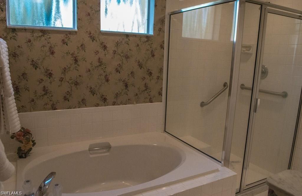 5817 Glencove Drive, Unit 404 Naples, FL 34108 - Photo 12 of 21 a bathroom with a bathtub