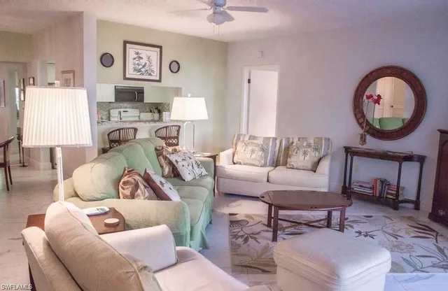 a living room with furniture a rug and a window