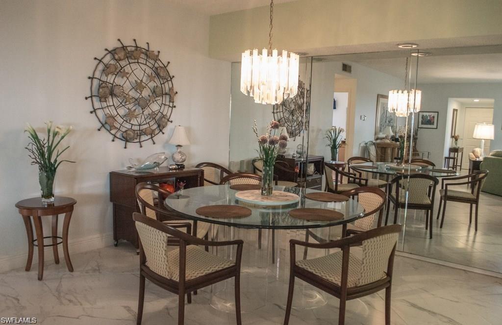 5817 Glencove Drive, Unit 404 Naples, FL 34108 - Photo 5 of 21 a dining room with furniture and window