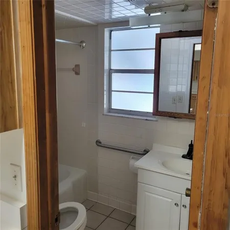 a kitchen with stainless steel appliances a sink a stove a refrigerator cabinets and island