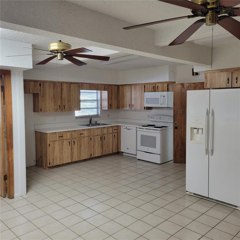 1661 Votaw Road Apopka, FL 32703 - Photo 17 of 23 a kitchen with stainless steel appliances a sink a stove a refrigerator cabinets and island