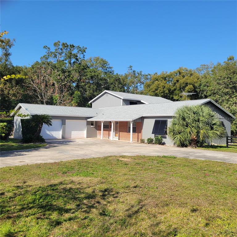 1661 Votaw Road Apopka, FL 32703 - Photo 7 of 23 a front view of a house with a yard