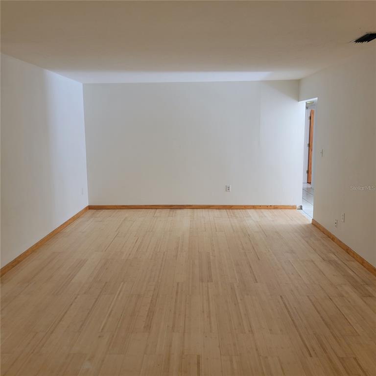 1661 Votaw Road Apopka, FL 32703 - Photo 10 of 23 a view of an empty room with wooden floor