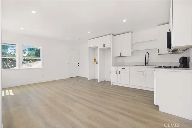 a view of kitchen with granite countertop cabinets and wooden floor