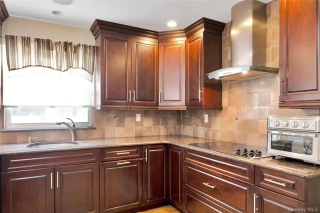 a kitchen with stainless steel appliances granite countertop a sink a stove and a microwave