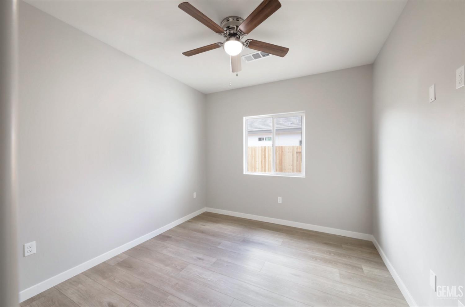 Undisclosed Address Shafter, CA 93263 - Photo 12 of 33 an empty room with a window and a fan