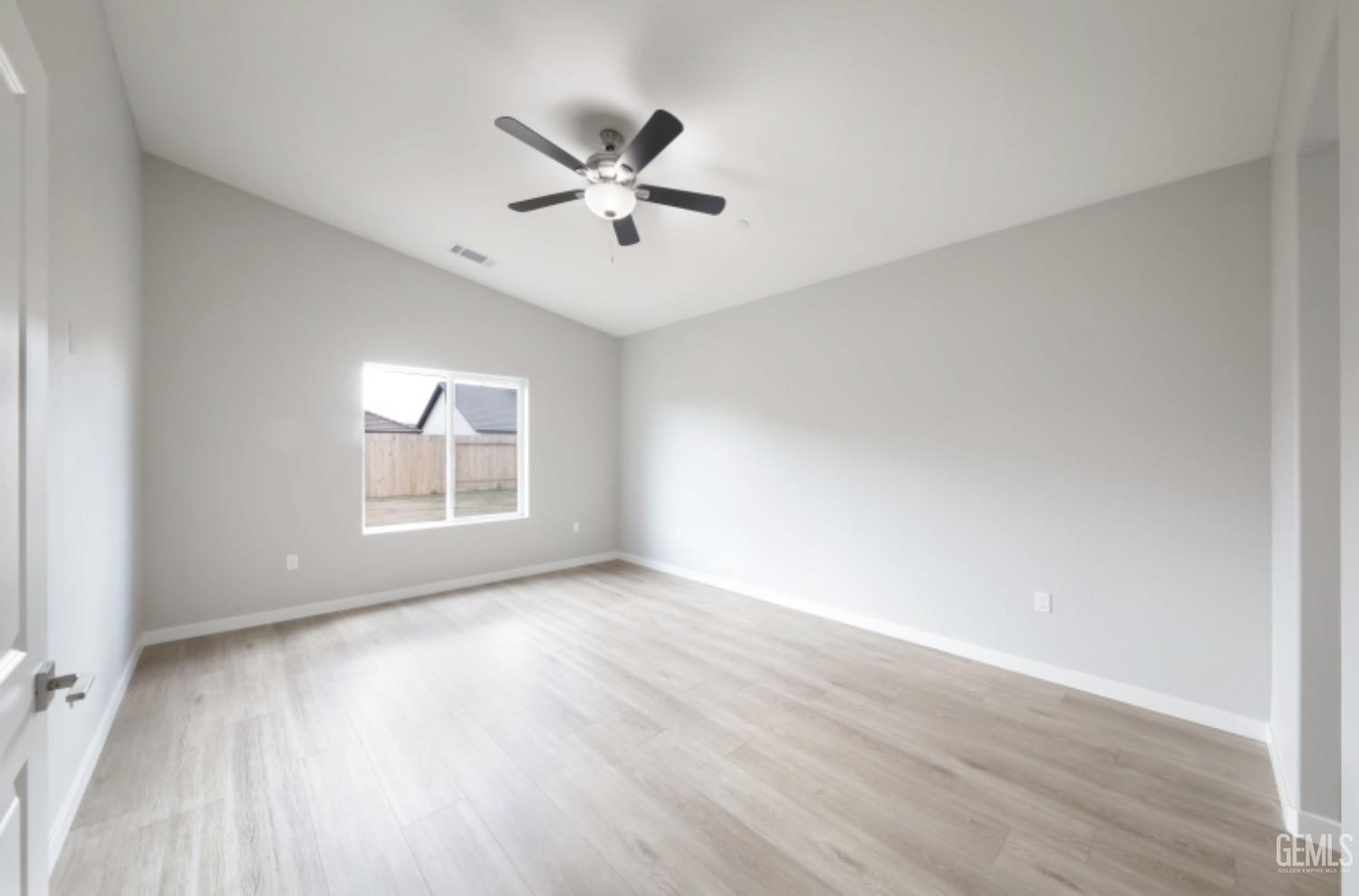 Undisclosed Address Shafter, CA 93263 - Photo 15 of 33 a view of an empty room with wooden floor and a window