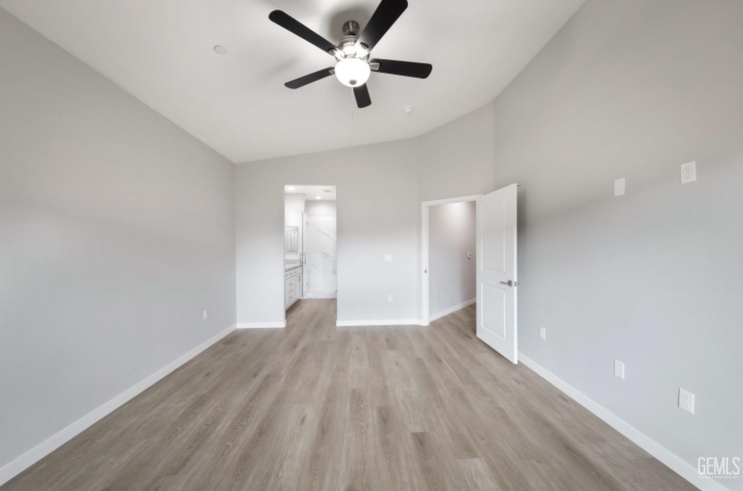 Undisclosed Address Shafter, CA 93263 - Photo 16 of 33 an empty room with wooden floor and a ceiling fan