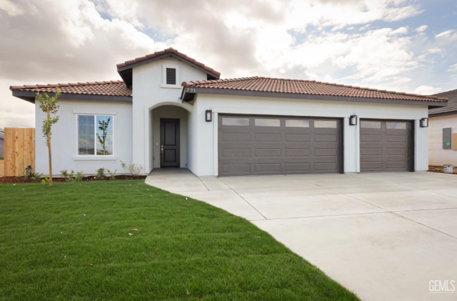 Undisclosed Address Shafter, CA 93263 - Photo 2 of 33 a front view of a house with a yard and garage