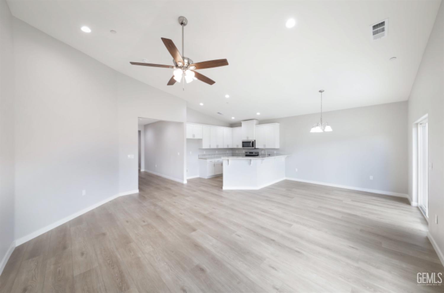 Undisclosed Address Shafter, CA 93263 - Photo 23 of 33 an empty room with wooden floor ceiling fan and windows