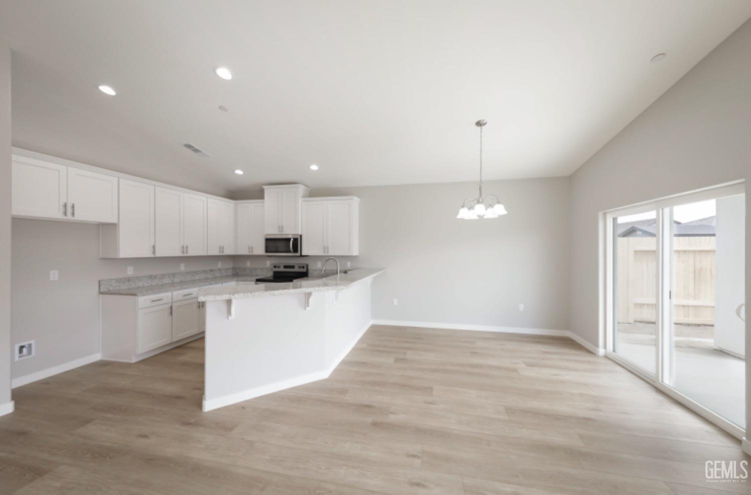 Undisclosed Address Shafter, CA 93263 - Photo 24 of 33 a kitchen with kitchen island white cabinets and window