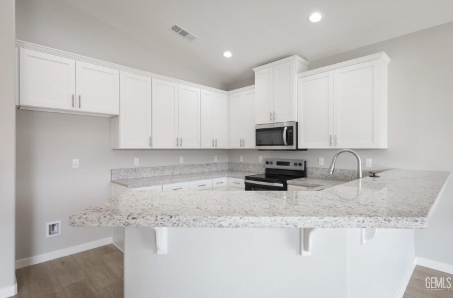Undisclosed Address Shafter, CA 93263 - Photo 27 of 33 a kitchen with granite countertop white cabinets stainless steel appliances and a sink