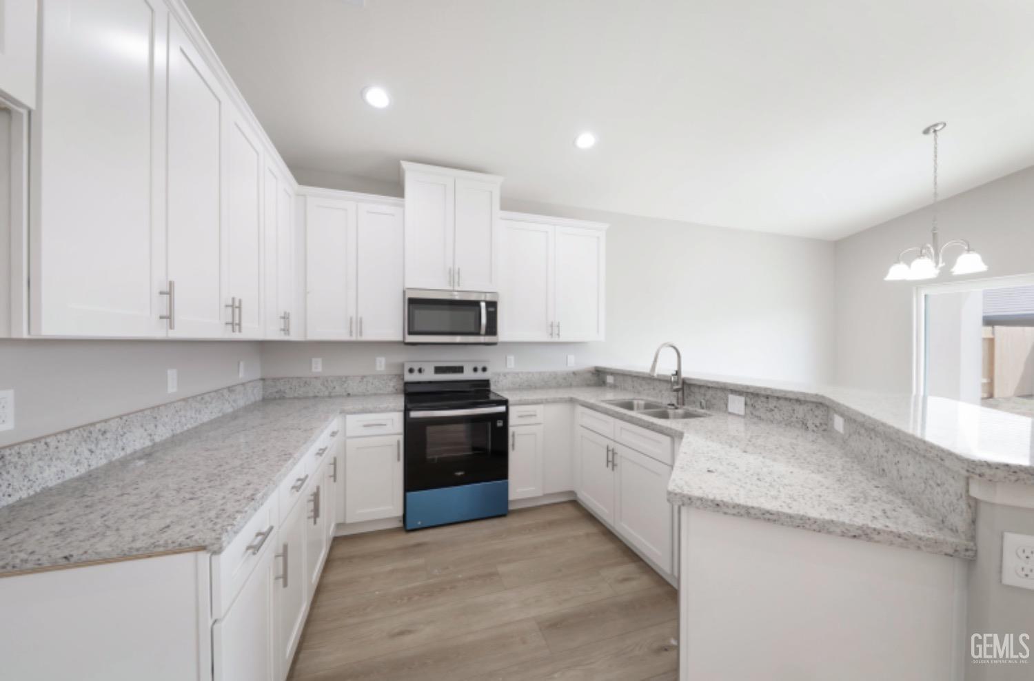 Undisclosed Address Shafter, CA 93263 - Photo 28 of 33 a large kitchen with stainless steel appliances granite countertop a stove a sink and a granite counter tops