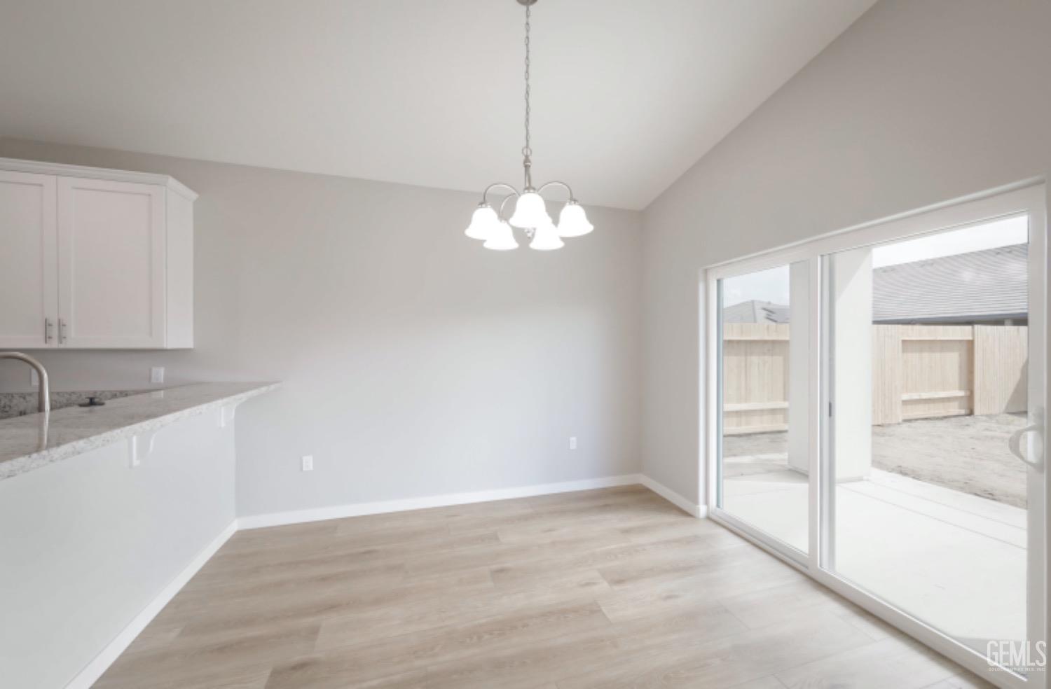 Undisclosed Address Shafter, CA 93263 - Photo 29 of 33 a view of a kitchen with a sink and dishwasher with wooden floor