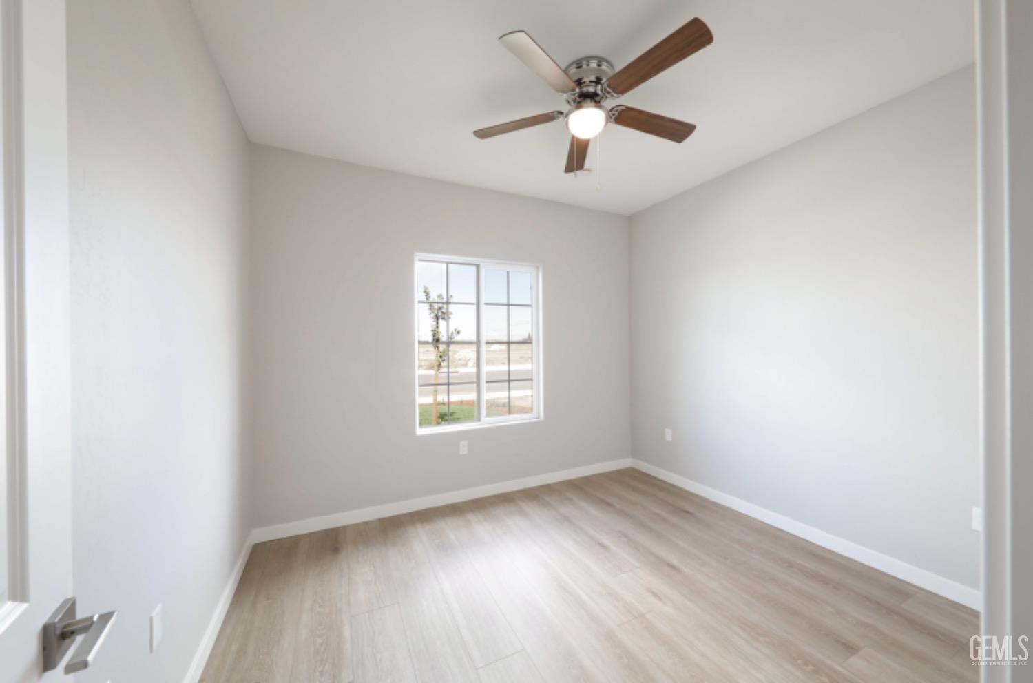 Undisclosed Address Shafter, CA 93263 - Photo 6 of 33 an empty room with wooden floor and windows