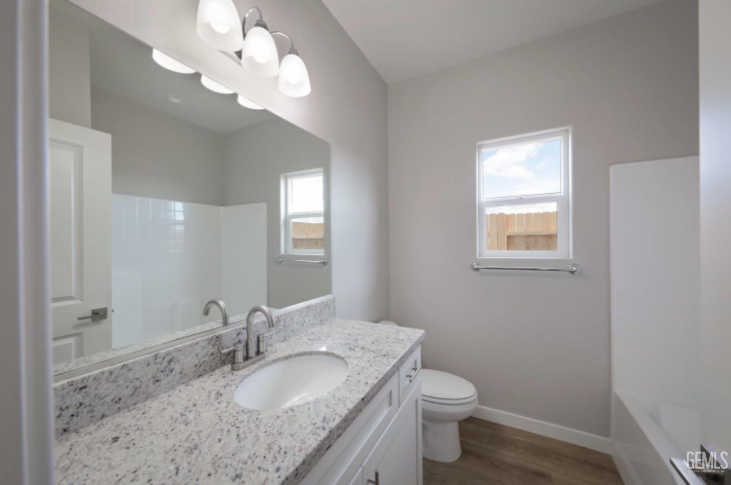 Undisclosed Address Shafter, CA 93263 - Photo 7 of 33 a bathroom with a granite countertop double vanity sink and a mirror