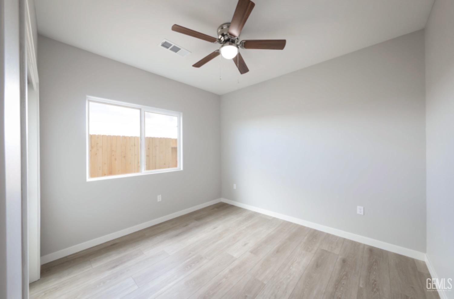 Undisclosed Address Shafter, CA 93263 - Photo 8 of 33 an empty room with a window and a fan