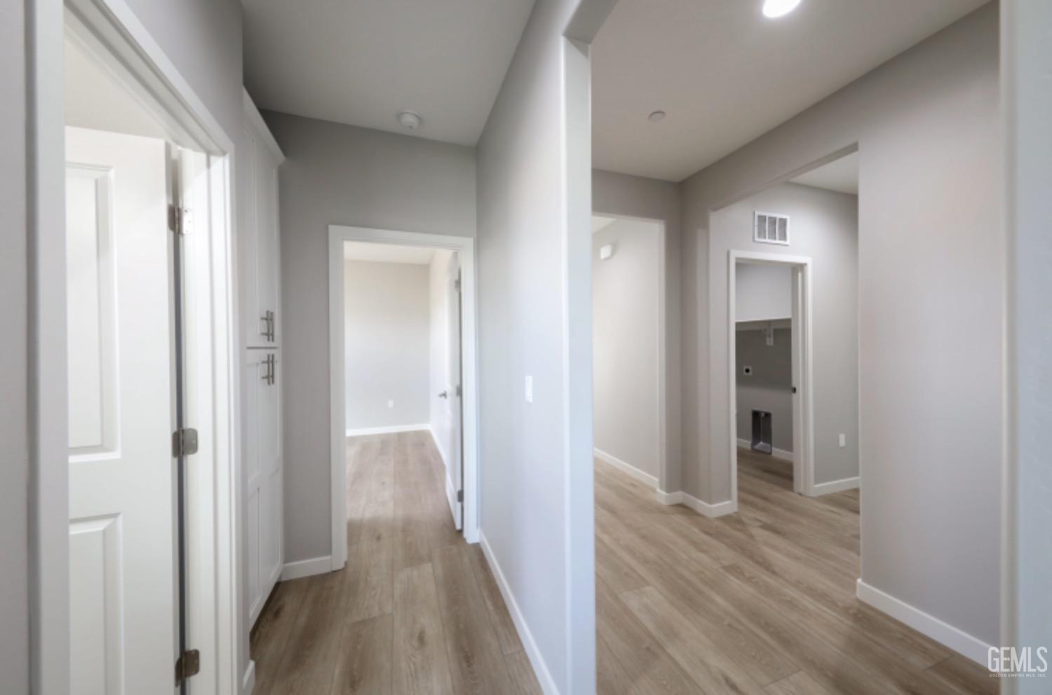 Undisclosed Address Shafter, CA 93263 - Photo 9 of 33 a view of a hallway with wooden floor