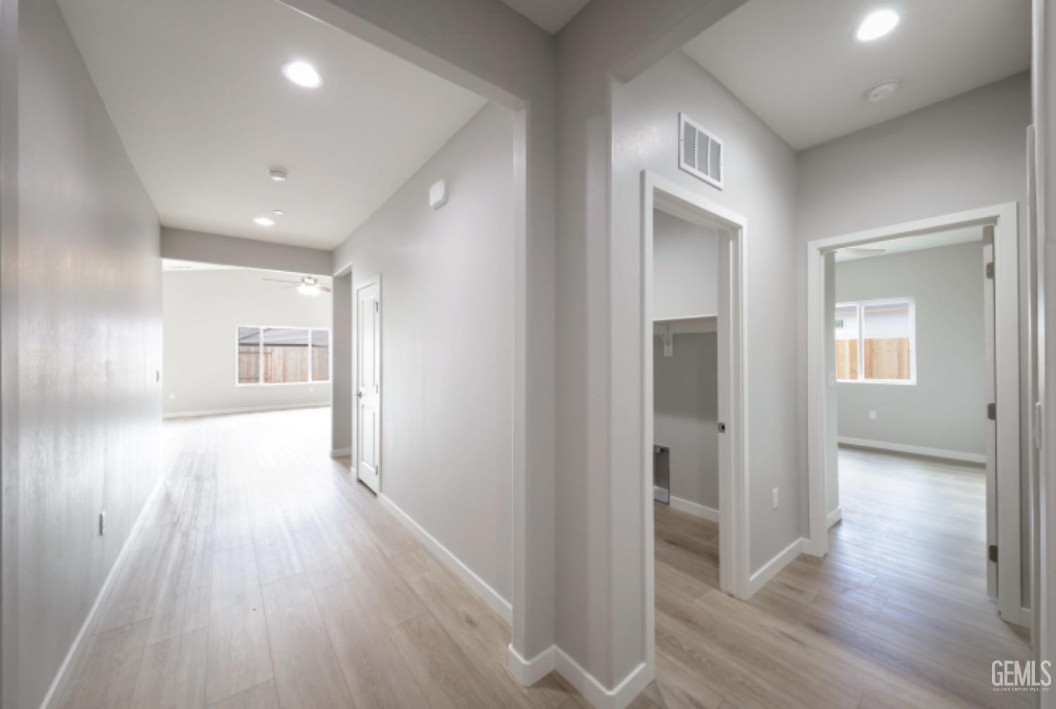 Undisclosed Address Shafter, CA 93263 - Photo 10 of 33 a view of a hallway with wooden floor and closet